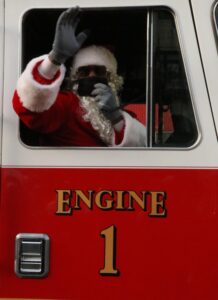 Santa Rides Through the City on a Trenton Fire Department Truck